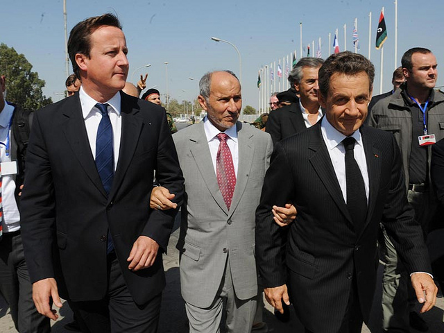 David Cameron and Nicolas Sarkozy walking Mustafa Abdel Jalil 