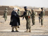 Soldier of the Afghan National Army shaking hands with a local 